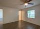 Bright bedroom with wood-look floors, two doorways, and a window for natural light at 9 Pine Radial Ct, Ocala, FL 34472