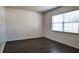 Bright, spacious bedroom with a large window and dark wood-look flooring at 9 Pine Radial Ct, Ocala, FL 34472