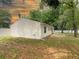 Side view of the property showcasing white siding, landscaped yard, and a classic design at 9 Pine Radial Ct, Ocala, FL 34472