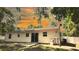 Rear exterior of a single-story home with a patio and a spacious, tree-filled backyard at 9 Pine Radial Ct, Ocala, FL 34472