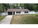 Charming single-story home with a well-maintained lawn and white picket fence at 9 Pine Radial Ct, Ocala, FL 34472