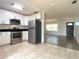 Open concept kitchen featuring stainless appliances connects to a spacious living room at 9 Pine Radial Ct, Ocala, FL 34472