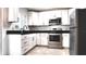 Modern kitchen with stainless appliances, black countertops, and ample cabinet space at 9 Pine Radial Ct, Ocala, FL 34472