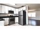 Updated kitchen with stainless steel appliances and white cabinetry at 9 Pine Radial Ct, Ocala, FL 34472