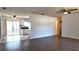 Open living room with dark wood-look floors leading to a tiled kitchen and dining area at 9 Pine Radial Ct, Ocala, FL 34472