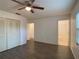Spacious main bedroom featuring dark wood-look floors, closet, and bathroom access at 9 Pine Radial Ct, Ocala, FL 34472