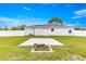 This backyard features a concrete area for outdoor enjoyment, with a privacy fence and ample green space at 97 Dogwood Cir, Ocala, FL 34472