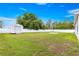 Large grassy backyard features privacy fence, mature trees, and shed at 97 Dogwood Cir, Ocala, FL 34472