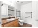 Bathroom with a wood vanity, stylish hardware, and a shower behind glass door at 97 Dogwood Cir, Ocala, FL 34472