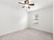 Bright bedroom with plush carpeting, a ceiling fan, and a window for natural light at 97 Dogwood Cir, Ocala, FL 34472