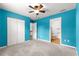 Spacious bedroom features plush carpeting, a ceiling fan, and access to an ensuite bathroom at 97 Dogwood Cir, Ocala, FL 34472