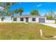 Charming single-story home with a well-maintained lawn, a grey roof and shutters, and a paved driveway at 97 Dogwood Cir, Ocala, FL 34472