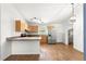 Well-lit kitchen with modern appliances, wood cabinetry, breakfast bar, and wood-look flooring at 97 Dogwood Cir, Ocala, FL 34472