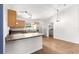 Well-lit kitchen with modern appliances, wood cabinetry, breakfast bar, and wood-look flooring at 97 Dogwood Cir, Ocala, FL 34472
