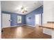 Bright living room featuring wood-look flooring, ceiling fan, and easy access to adjacent rooms at 97 Dogwood Cir, Ocala, FL 34472