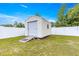 Backyard shed with ramp, surrounded by grass and a white privacy fence at 97 Dogwood Cir, Ocala, FL 34472