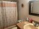 Cozy bathroom featuring a shower with curtain, a sink, and a mirror at 9920 Sw 102Nd Pl, Ocala, FL 34481