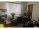 This cozy bedroom is staged as an office featuring natural lighting from the windows at 9920 Sw 102Nd Pl, Ocala, FL 34481