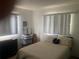 This cozy bedroom featuring natural lighting from the windows at 9920 Sw 102Nd Pl, Ocala, FL 34481
