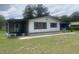 Charming single-story home with a screened porch and covered parking area, set on a well-maintained lawn at 9920 Sw 102Nd Pl, Ocala, FL 34481