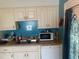 Traditional kitchen featuring white cabinets, stainless sink and modern appliances at 9920 Sw 102Nd Pl, Ocala, FL 34481