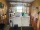 Functional laundry area with a washer, dryer, water heater, shelving and pegboard for storage at 9920 Sw 102Nd Pl, Ocala, FL 34481