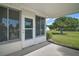 Covered back porch with sliding screen doors offers a comfortable outdoor area at 10347 Se 178Th Pl, Summerfield, FL 34491