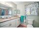 Bright bathroom featuring granite countertops, white cabinetry, and decorative butterfly curtain at 10347 Se 178Th Pl, Summerfield, FL 34491