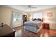 Cozy bedroom featuring natural light, a ceiling fan, and hardwood floors, creating a serene and inviting atmosphere at 10347 Se 178Th Pl, Summerfield, FL 34491