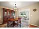 Inviting dining area featuring a classic chandelier and views into a bright sunroom at 10347 Se 178Th Pl, Summerfield, FL 34491