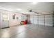 Spacious garage with ample storage space, a side door, and a two-car garage door at 10347 Se 178Th Pl, Summerfield, FL 34491