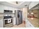 Well-lit kitchen featuring stainless steel appliances, granite counters, and white cabinets providing a modern culinary space at 10347 Se 178Th Pl, Summerfield, FL 34491