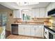 Bright kitchen with granite countertops, stainless steel dishwasher and cabinets providing ample storage and prep space at 10347 Se 178Th Pl, Summerfield, FL 34491