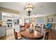 Open concept living and dining area with beautiful hardwood floors and ample natural light at 10347 Se 178Th Pl, Summerfield, FL 34491