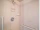 Tiled shower with grab bars and adjustable shower head offering safety and convenience at 10347 Se 178Th Pl, Summerfield, FL 34491