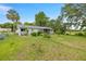 Spacious backyard with lush green grass surrounding the house in a tranquil setting at 11091 Sw 76Th Ter, Ocala, FL 34476