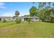 Expansive backyard showcasing the home's exterior and beautiful landscaping at 11091 Sw 76Th Ter, Ocala, FL 34476