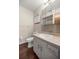 Well-lit bathroom featuring a vanity with a sink, mirror, and a toilet, offering a functional space at 11091 Sw 76Th Ter, Ocala, FL 34476