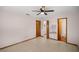 Spacious bedroom featuring tile floors, a ceiling fan, and access to a walk-in closet and ensuite bathroom at 11091 Sw 76Th Ter, Ocala, FL 34476