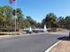 Community entrance with fountain and lush landscaping at 11091 Sw 76Th Ter, Ocala, FL 34476