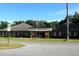 Charming brick building featuring an American flag and well-maintained landscaping at 11091 Sw 76Th Ter, Ocala, FL 34476