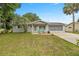 Charming single-story home featuring a well-maintained lawn and a welcoming front porch at 11091 Sw 76Th Ter, Ocala, FL 34476