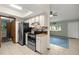 Galley-style kitchen featuring stainless appliances and a skylight for natural light at 11091 Sw 76Th Ter, Ocala, FL 34476