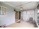 Enclosed patio featuring tile flooring, ceiling fan, and sliding glass doors for indoor/outdoor living at 11091 Sw 76Th Ter, Ocala, FL 34476