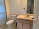 Functional bathroom with a vanity, toilet, and shower, offering essential amenities in a clean setting at 11445 Sw 84Th Avenue Rd, Ocala, FL 34481