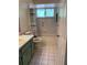 A clean bathroom with tile flooring and combination tub and shower at 11445 Sw 84Th Avenue Rd, Ocala, FL 34481