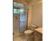 Practical bathroom featuring a shower with sliding glass doors, toilet, and a simple vanity area at 11445 Sw 84Th Avenue Rd, Ocala, FL 34481