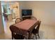 Inviting dining area with a wooden table, tile floors, and a view into the kitchen at 11445 Sw 84Th Avenue Rd, Ocala, FL 34481