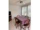 Inviting dining room with large windows, neutral tile flooring, and a wooden table set for four at 11445 Sw 84Th Avenue Rd, Ocala, FL 34481