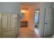 Dressing area with vanity and storage leading to the bathroom, providing a private and convenient space at 11445 Sw 84Th Avenue Rd, Ocala, FL 34481